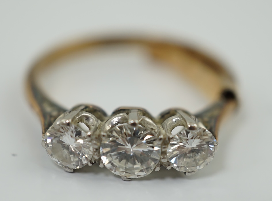 An 18ct gold, platinum and three stone diamond set ring